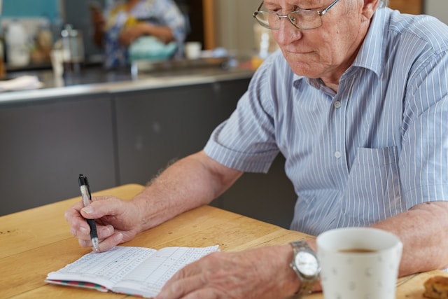man writing in notebook