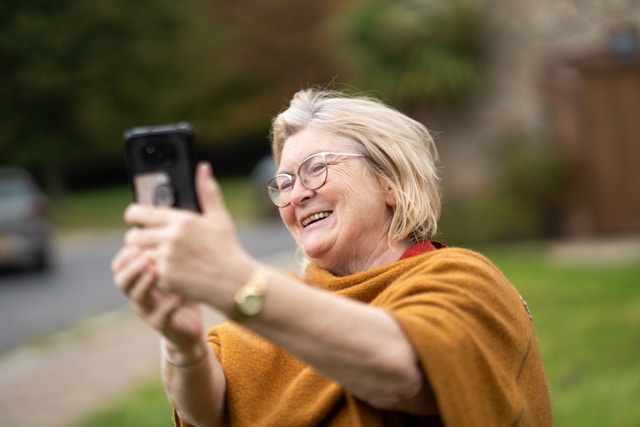 senior woman on video call using smartphone