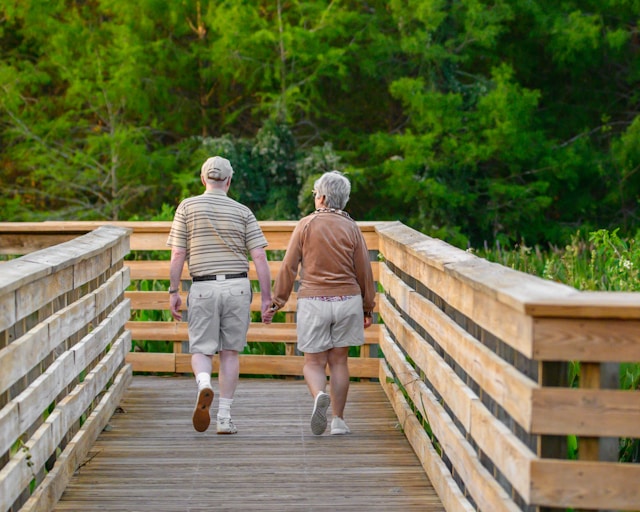a senior couple on a walk holding hands