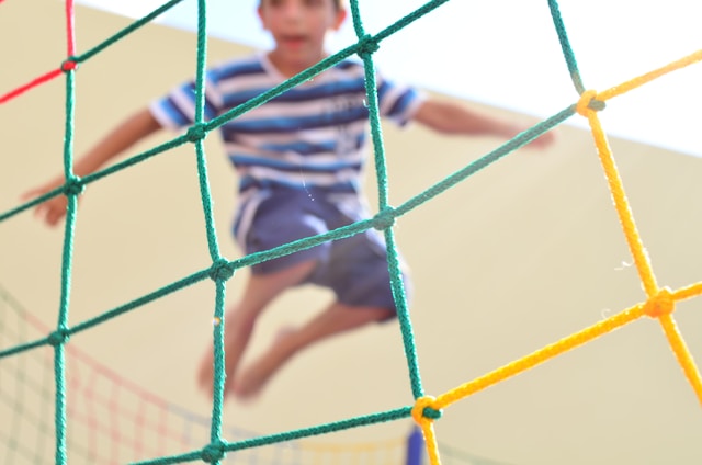 boy jumping on trampoline