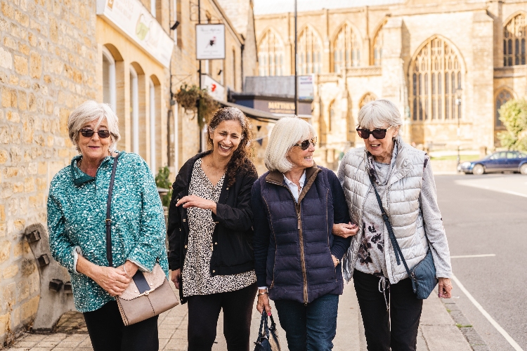 Group of senior women walking down a road