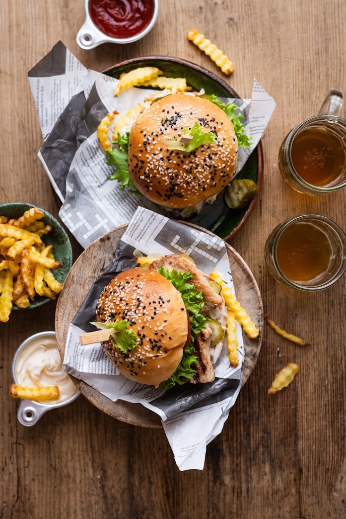 burgers and beer laid out on table