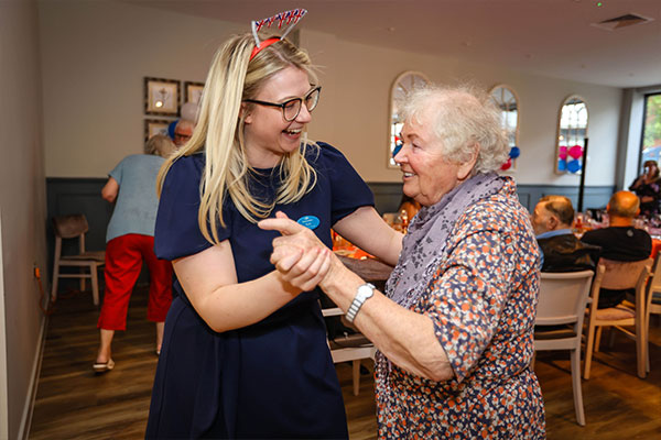 Community Manager dancing with resident