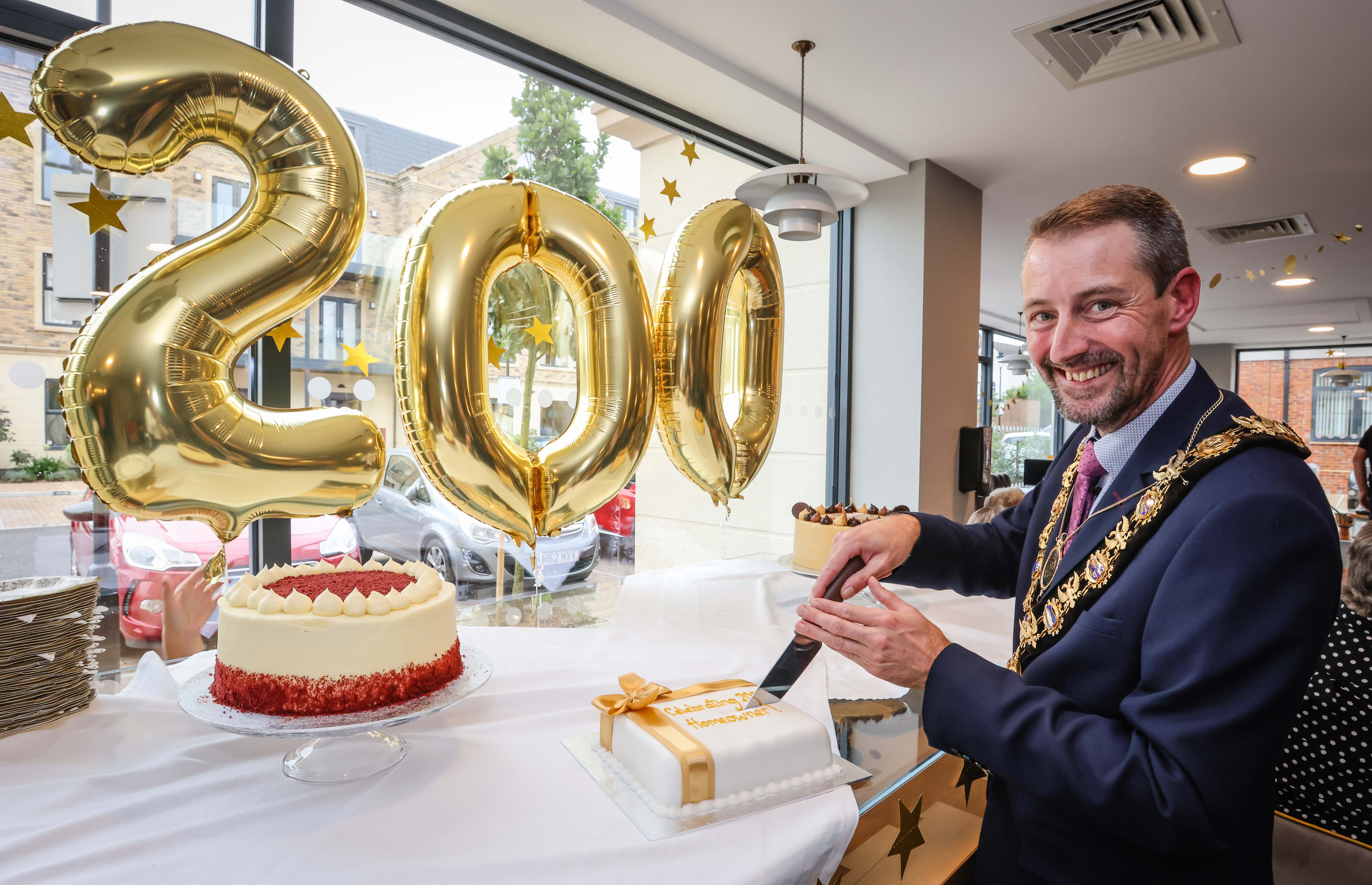 The Mayor of Salisbury cutting a cake at Platinum Skies Chapters