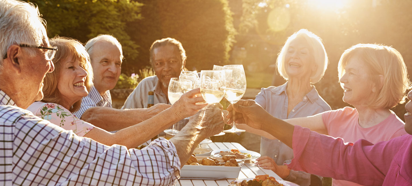 Residents enjoying a cheers moment in the garden with some drinks